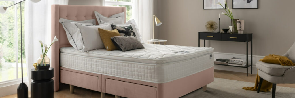 A pink Silentnight Bloomsbury Divan Bed in a bedroom
