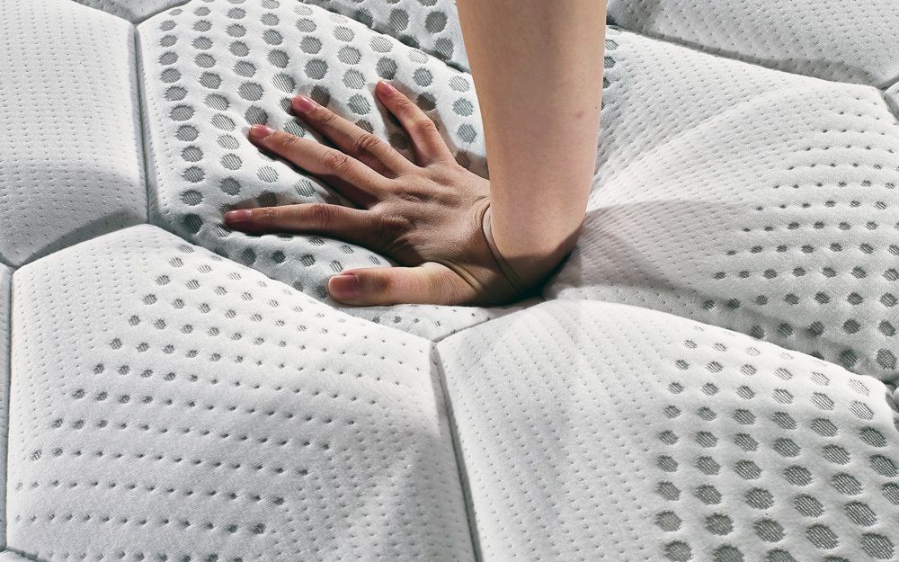 A reflex foam mattress showing the response against a hand when pressure is applied