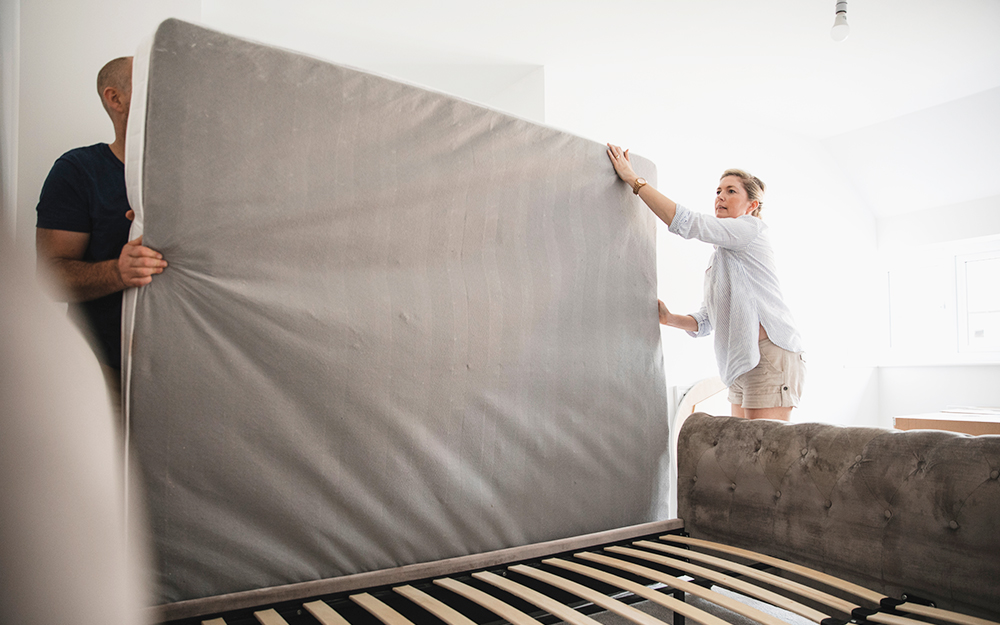 Couple moving mattress together