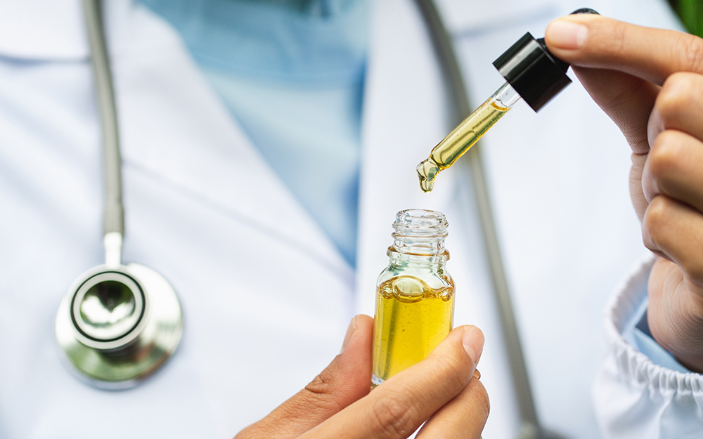 A doctor holding CBD oil