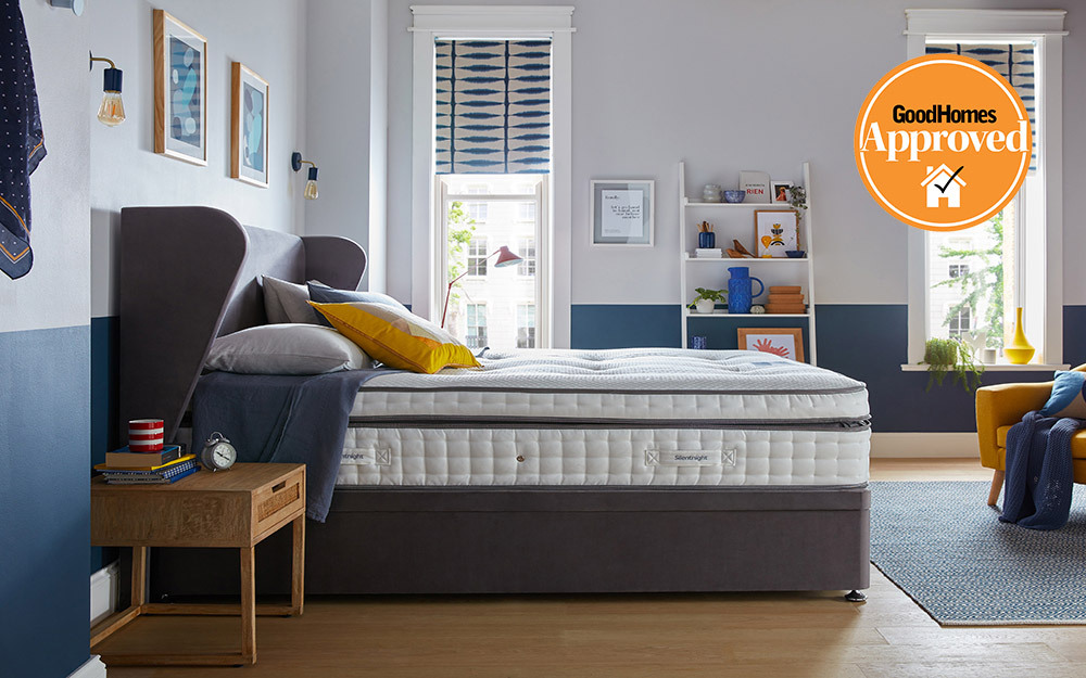 The Silentnight Geltex Ultra 3000 Mirapocket Firmer Mattress on a fabric bed in a blue, teenagers room.