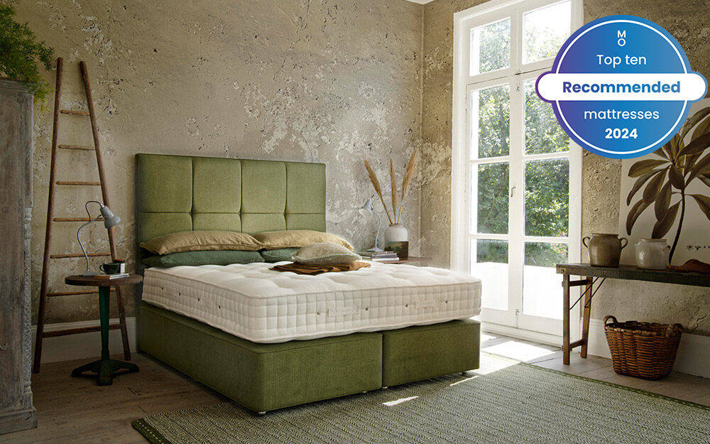 Image of the Hypnos Winslow Luxury Wool Mattress on top of a green bed frame. Included in the image is a badge overlay stating that this mattress is one of Mattress Online's top ten recommended mattresses of 2024.