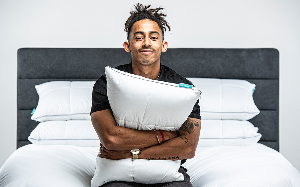 Man hugging a Nectar Adjustable Memory Foam Pillow