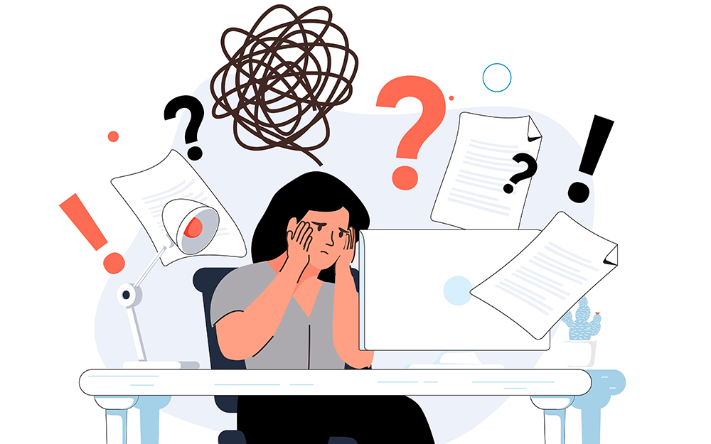 An illustration of a person at work feeling stressed surrounded by papers.