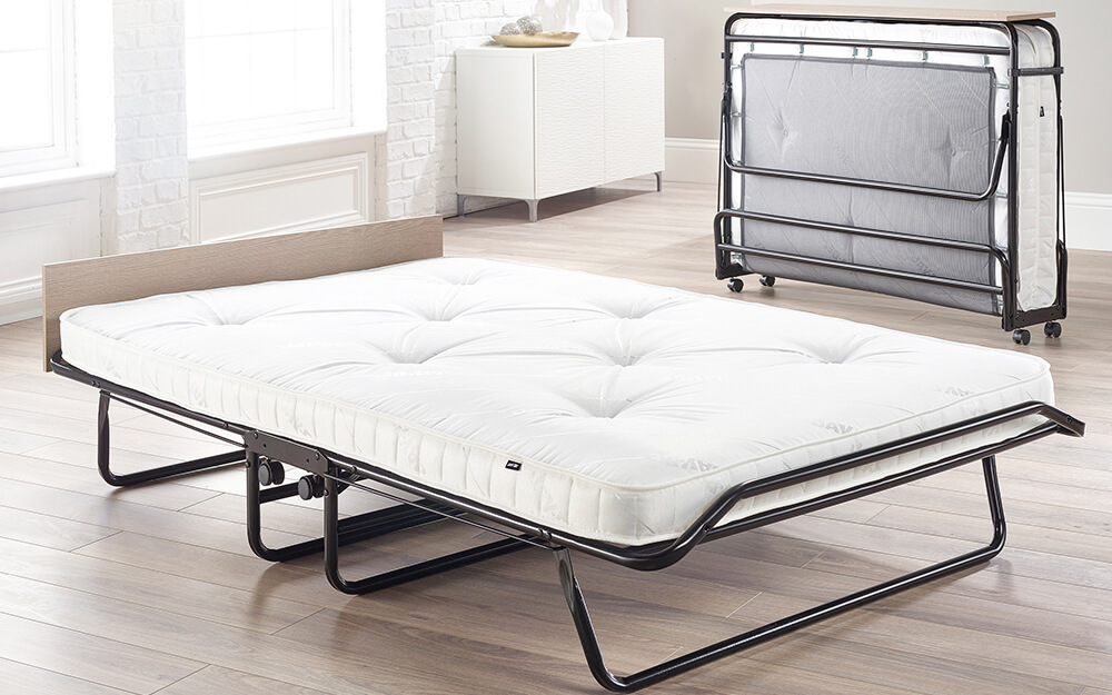 The Jay-Be Supreme Folding bed with Micro e-Pocket Mattress in a white guest room.