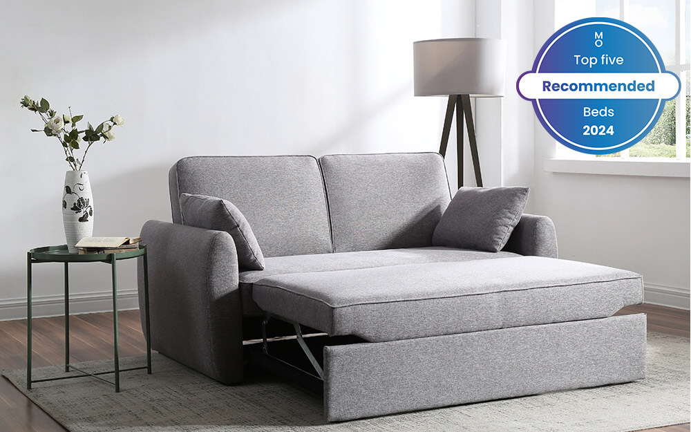 Grey sofa with extended seat cushion that resembles a bed.