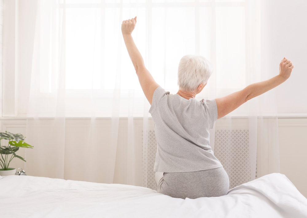 Woman stretching after a good nights sleep