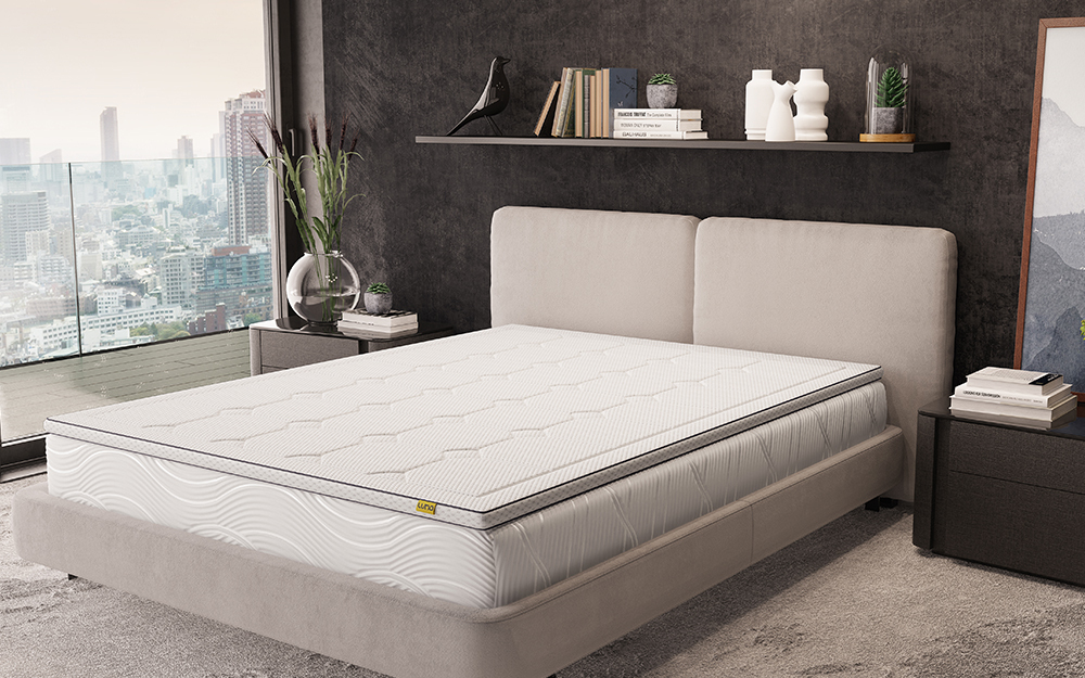 The Luna Gel Memory Mattress Topper on a bed in a modern apartment