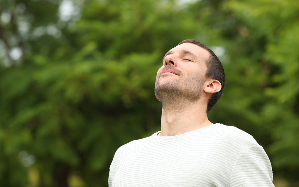 Man with eyes closed enjoying nature.