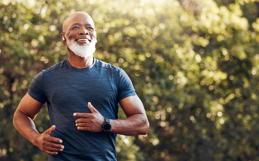 Fit older man with grey beard jogging.