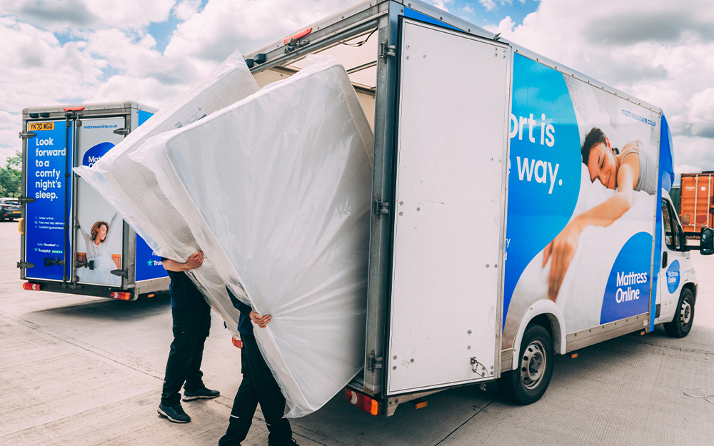 Staff loading mattresses onto a Mattress Online delivery van