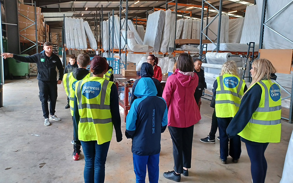 A small class of children from the See It Be It scheme having a tour of the Mattress Online warehouses.