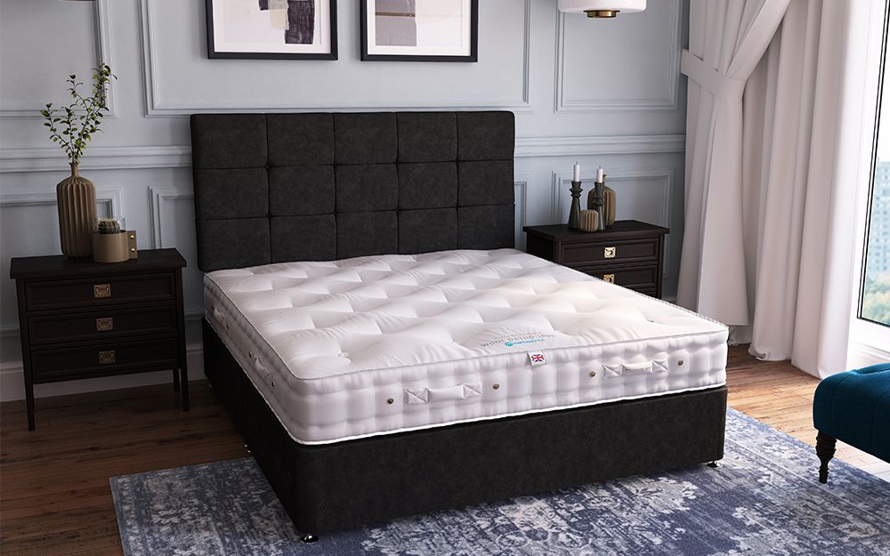 The Millbrook Wool Ortho 1000 Pocket Mattress in a luxurious hotel room on a black divan bed