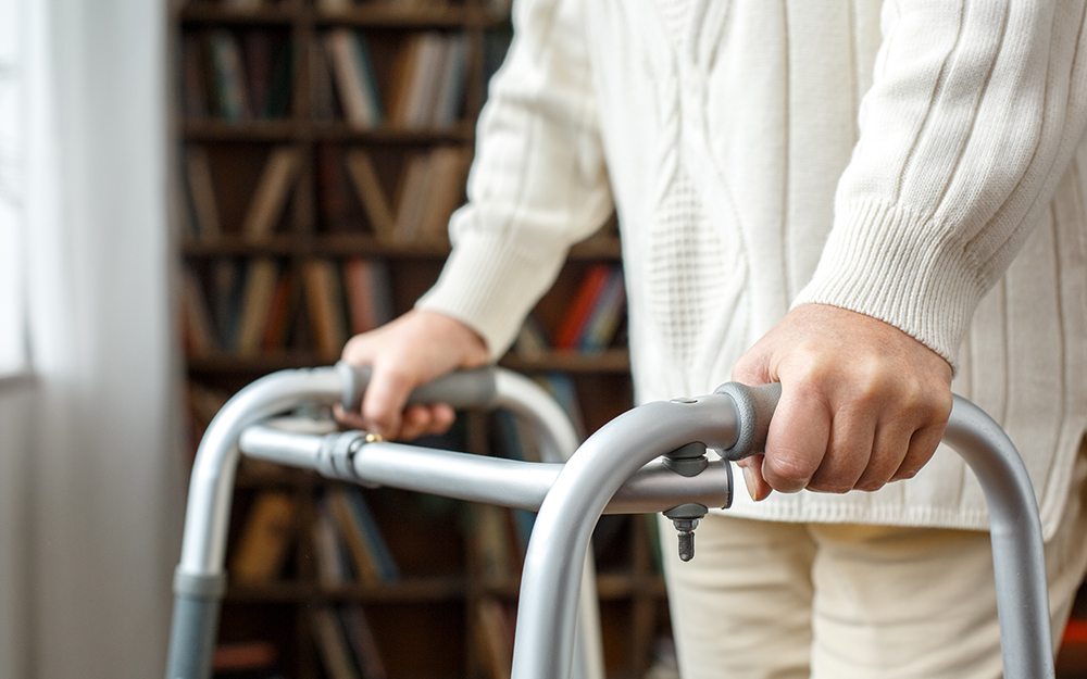 An older woman using a walker