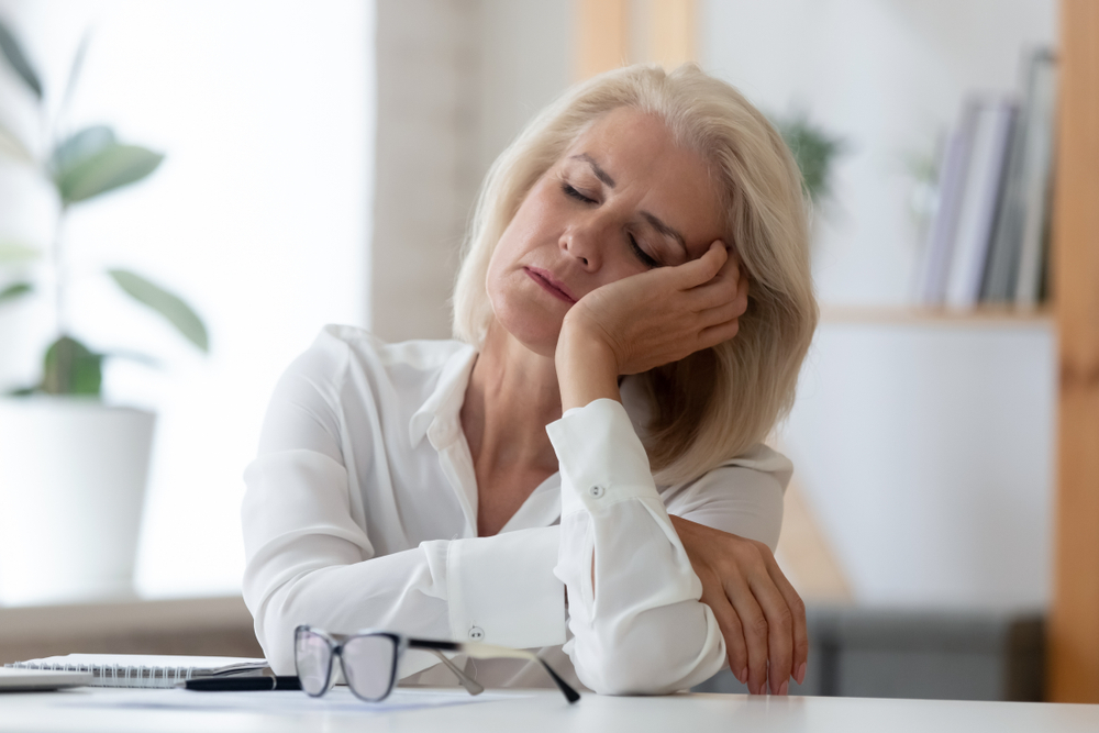 Older woman asleep at desk