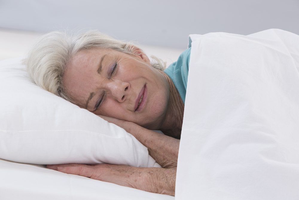 Older woman sleeping in bed