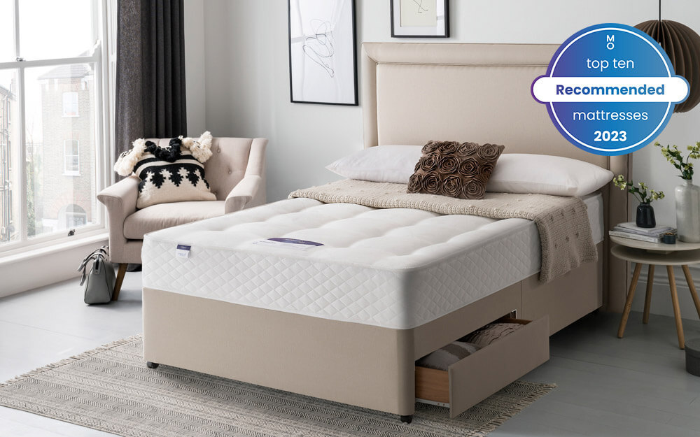 The Silentnight Ortho Dream Star Miracoil Mattress in a white and pale pink bedroom - one of our top 10 recommended mattresses 2023