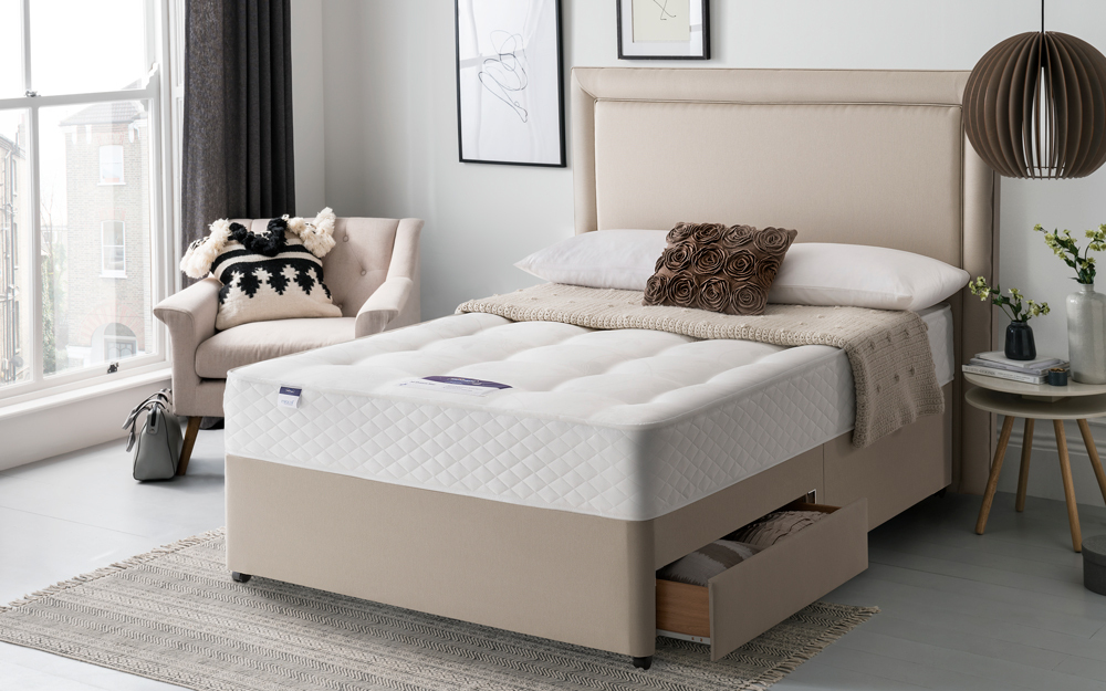 The platform base Silentnight Ortho Dream Star Miracoil Divan Bed in a bedroom with two drawers open