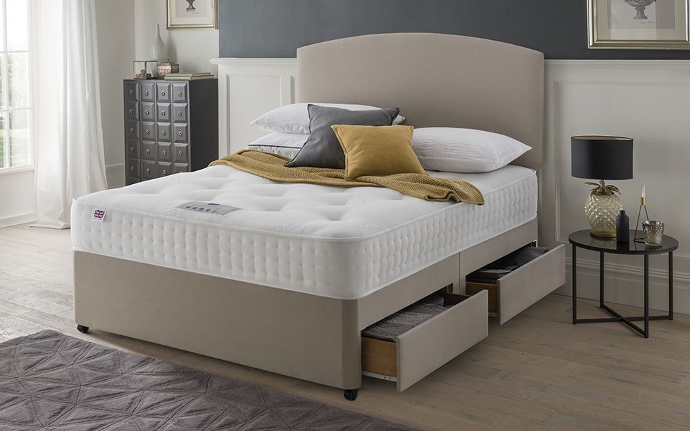 The Rest Assured Novaro 1000 Pocket Ortho Mattress on a sand-coloured divan bed with two drawers.