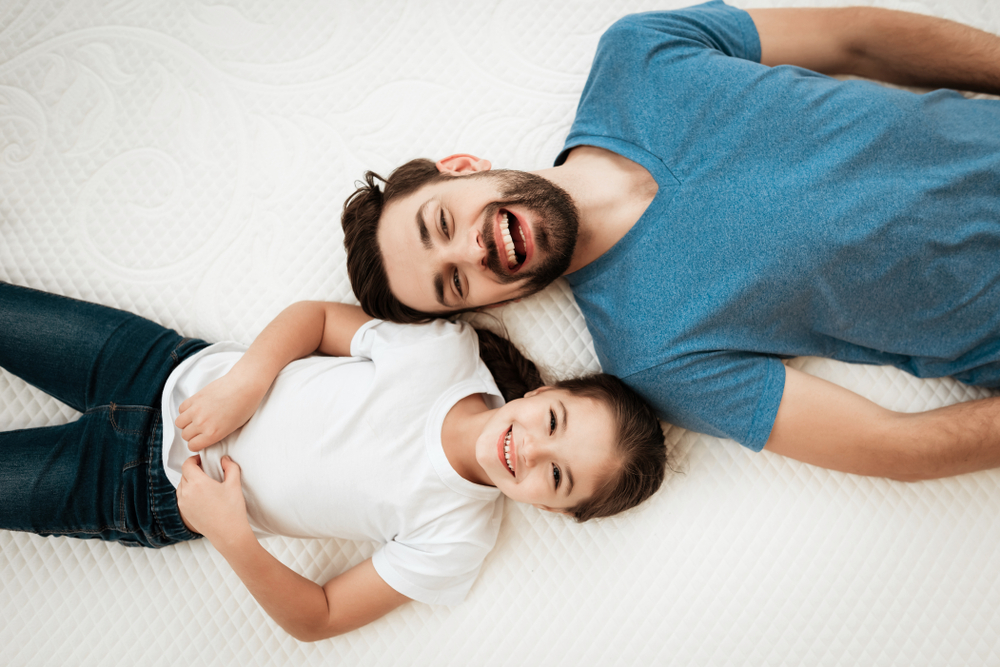 Man and child on bed