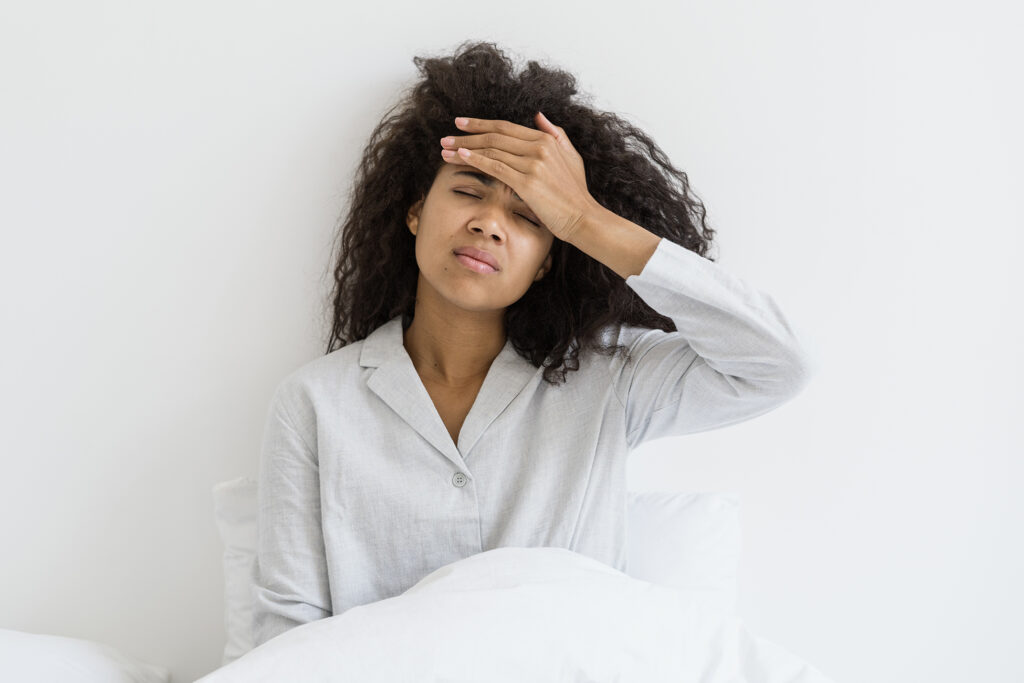 Woman with headache holding head