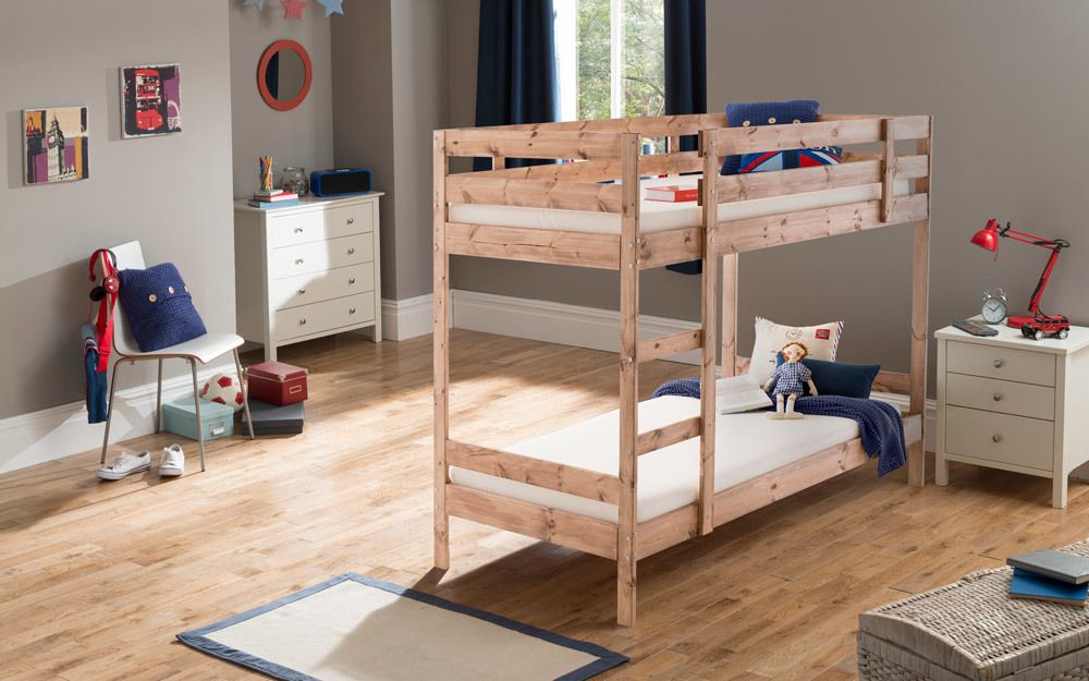 A wooden bunk bed in the middle of a kid's room