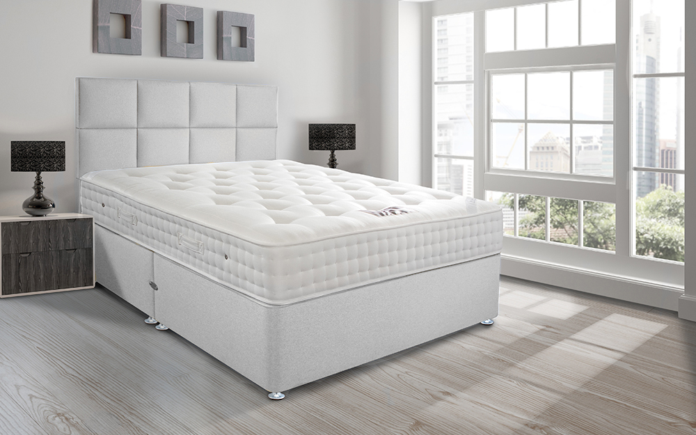 Sleepeezee Hotel Supreme 1400 Pocket Contract Mattress in a white hotel room with floor to ceiling windows.