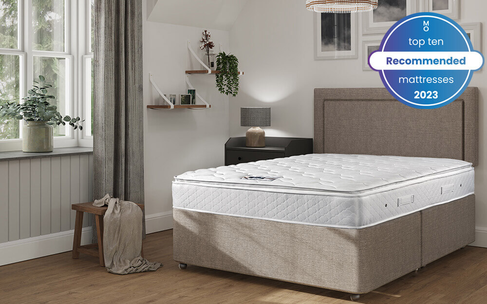 The Sleepeezee Memory Comfort 1000 Pocket Pillow Top Mattress in a grey bedroom - one of our top ten recommended mattresses 2023