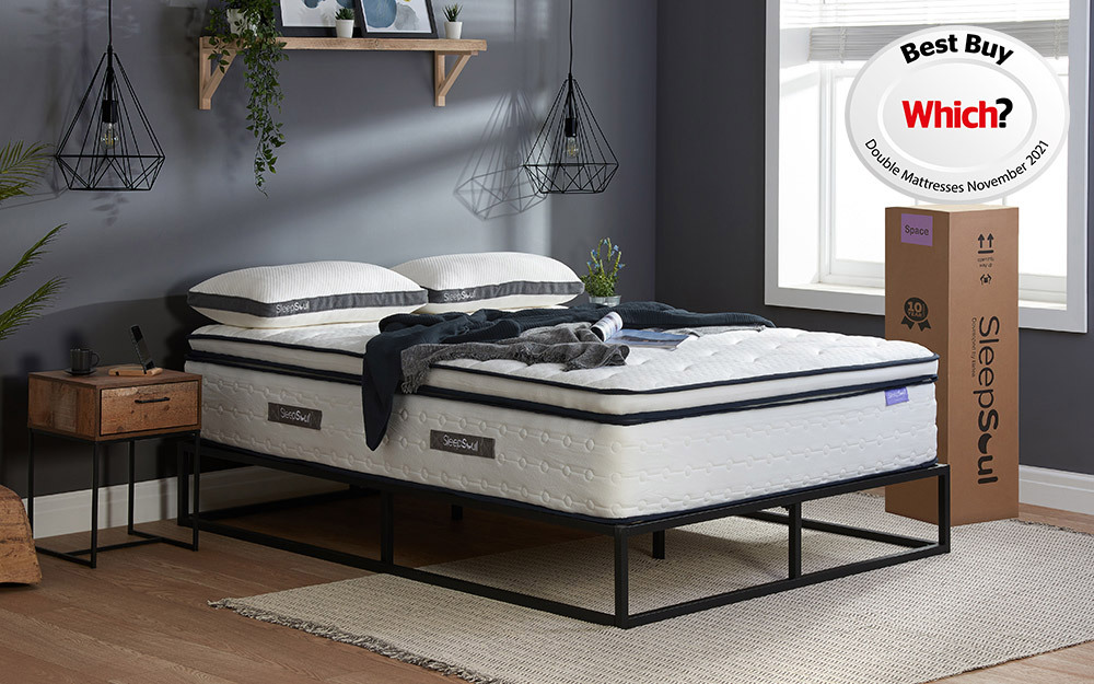 The SleepSoul Space 2000 Pocket Memory Pillow Top Mattress on a black metal bed in a dark blue bedroom.