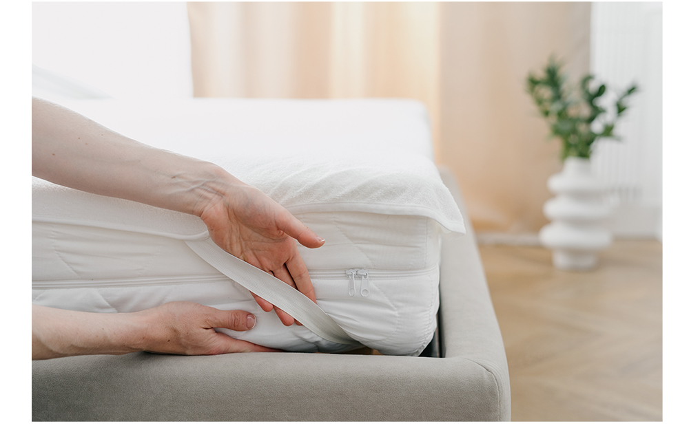 Person testing a mattress topper's size on their mattress