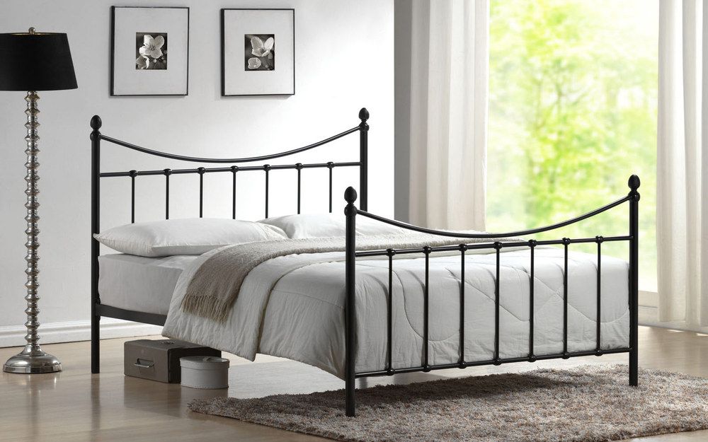 A black Time Living Alderly Metal Bed in a bedroom that is decorated in black and white.