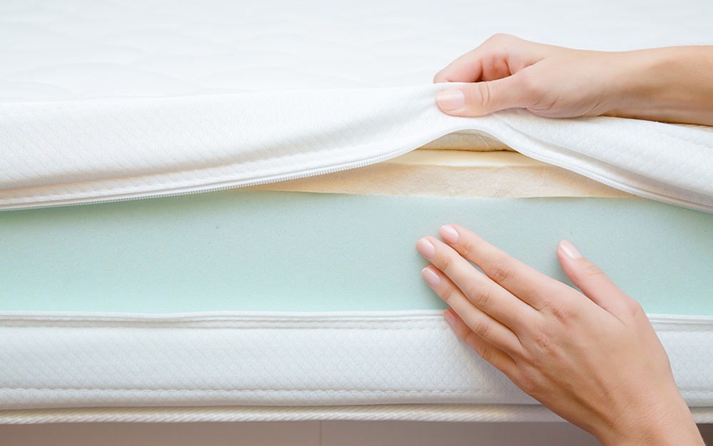 Woman showing the foam inside a mattress 