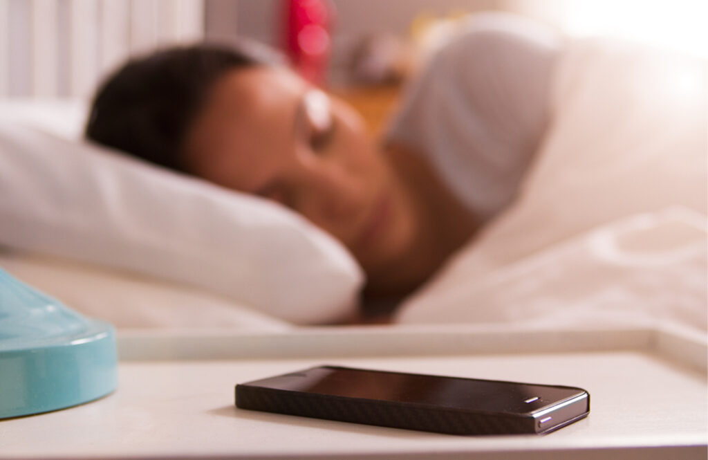 Woman sleeping with smartphone turned off