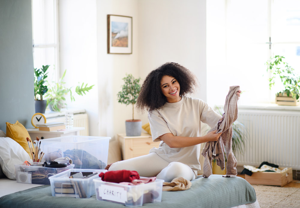 Girl smiling with decluttering her bedroom